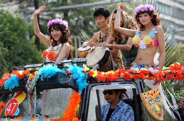 Young people drive their private car to take part in a carnival parade marking the opening of the 2010 Kunming Tourism Festival in Kunming, capital of southwest China's Yunnan Province, May 1, 2010, [Xinhua/Lin Yiguang]