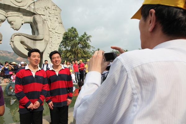 Chinese twin brothers have their photos taken during the Sixth Mojiang International Twins Festival which attracts nearly one thousand pairs of twins in Mojiang county, Yunnan province, May 2, 2010.