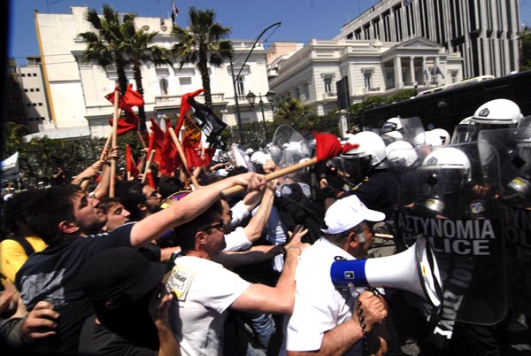 Greeks take part in a protest against the country&apos;s austerity measures in exchange for a massive bailout package from the European Union and the International Monetary Fund, in downtown Athens, capital of Greece, May 4, 2010.[Alexandros Stamatiou/Xinhua]