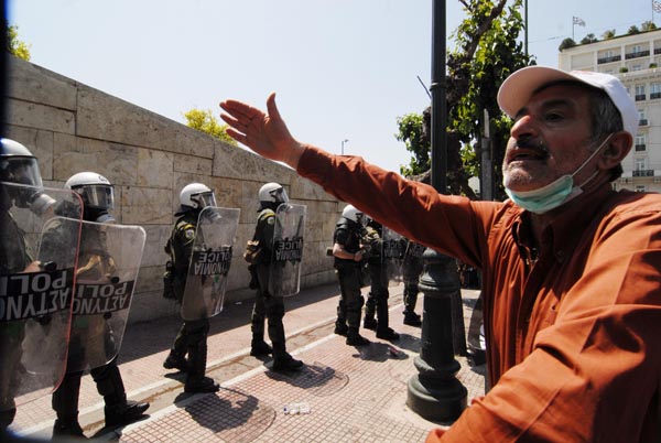 A Greek man takes part in a protest against the country&apos;s austerity measures in exchange for a massive bailout package from the European Union and the International Monetary Fund, in downtown Athens, capital of Greece, May 4, 2010. [Alexandros Stamatiou/Xinhua]