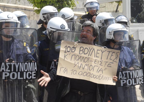 A Greek man takes part in a protest against the country&apos;s austerity measures in exchange for a massive bailout package from the European Union and the International Monetary Fund, in downtown Athens, capital of Greece, May 4, 2010. [Alexandros Stamatiou/Xinhua]