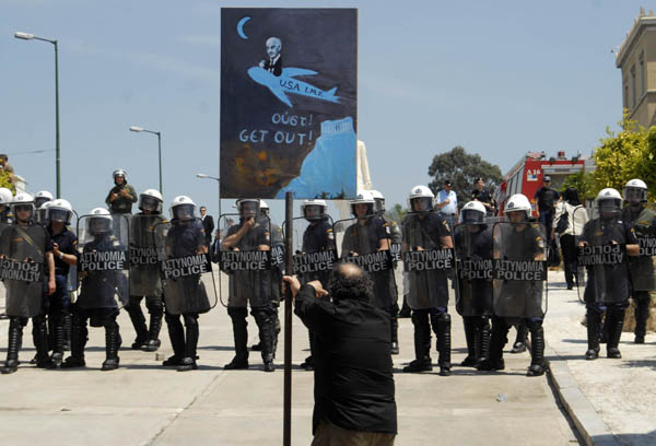 A Greek man takes part in a protest against the country&apos;s austerity measures in exchange for a massive bailout package from the European Union and the International Monetary Fund, in downtown Athens, capital of Greece, May 4, 2010. [Alexandros Stamatiou/Xinhua]