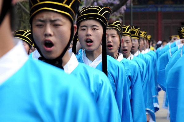 18-year-old students in Taiyuan, Shanxi province take an oath at the coming-of-age ceremony on May 4, 2010. Over 100 students, clad in traditional Han clothes, pay their respects to Confucius at the Shanxi Folk Custom Museum and bowed to their parents, to acknowledge they are adults. 