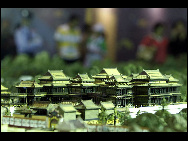 Visitors look at a mini replica of the Old Summer Palace at the Shanghai World Expo on May 4, 2010. The panorama replica of the Old Summer Palace was unveiled in the World Trade Center Pavilion at the Shanghai World Expo. Scaled down at a rate of 1:150, it represents the magnificent Old Summer Palace at its peak. [Xinhua]