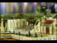 Visitors look at a mini replica of the Old Summer Palace at the Shanghai World Expo on May 4, 2010. The panorama replica of the Old Summer Palace was unveiled in the World Trade Center Pavilion at the Shanghai World Expo. Scaled down at a rate of 1:150, it represents the magnificent Old Summer Palace at its peak. [Xinhua]