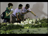 Visitors look at a mini replica of the Old Summer Palace at the Shanghai World Expo on May 4, 2010. The panorama replica of the Old Summer Palace was unveiled in the World Trade Center Pavilion at the Shanghai World Expo. Scaled down at a rate of 1:150, it represents the magnificent Old Summer Palace at its peak. [Xinhua]