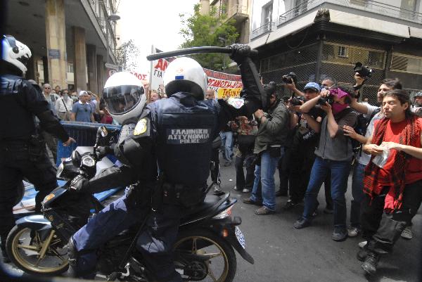 Riot police try to keep order during a protest in downtown Athens, capital of Greece, May 5, 2010. Three people died in a fire that broke out at a bank and some 40 others injured on Wednesday during a massive protest against austerity measures which turned out to be a violence in downtown Athens.[Phasma/Xinhua]