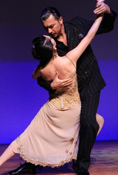 Actors perform Tango at Argentina Pavilion in the World Expo Park in Shanghai, east China, on May 5, 2010. The Argentina Pavilion is divided into indoor and outdoor parts with the former exhibiting pictures, traditional craft of the past 200 years in a multimedia way and the latter as an open green space for leisure. [Xinhua/Li Mingfang]