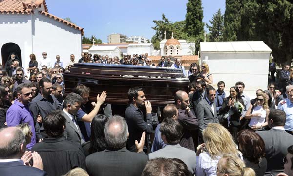 Relatives and friends take part in the funeral of a female bank clerk killed in the clash two days ago, in Athens, Greece, May 7, 2010. Three people were killed Wednesday in a fire that broke out at a bank in Athens during violent protests against austerity measures.