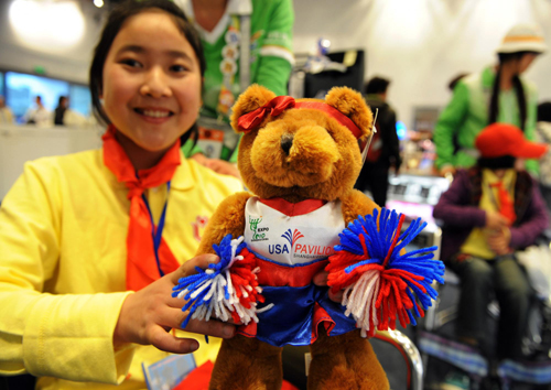 A disabled girl from a primary school of southwest China&apos;s Dujiangyan city, Sichuan province, selects souvenirs in the USA Pavilion at the Shanghai World Expo Site, May 8, 2010.
