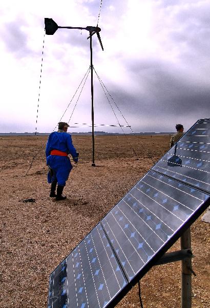 A local herdsman establishes solar and wind power equipment in Dong Ujimqin Qi, Xilingol, north China's Inner Mongolia Autonomous Region, May 8, 2010. 