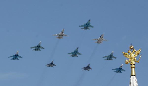 Military aircrafts fly above during a military parade marking the 65th anniversary of the victory over Nazi Germany in the Great Patriotic War, at the Red Square in Moscow May 9, 2010. [Lu Jinbo/Xinhua]