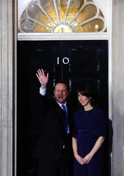 Britain's new Prime Minister Conservative party leader David Cameron (L) and his wife Samantha arrive at 10 Downing Street in London, on May 11, 2010. Cameron was appointed by Britain's Queen Elizabeth II as new prime minister. [Zeng Yi/Xinhua]