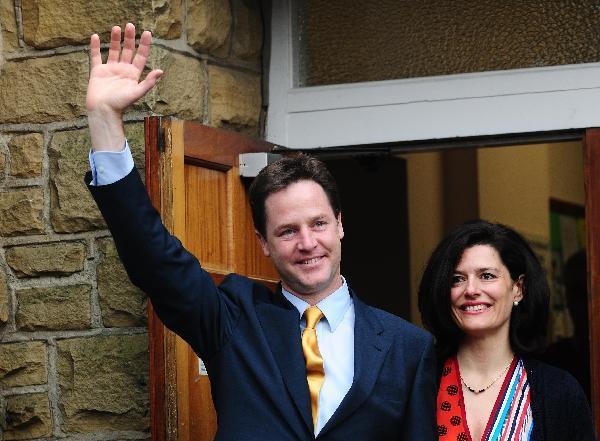 File photo taken on May 6, 2010 shows Liberal Democrats leader Nick Clegg (L) and his wife Miriam Gonzalez Durantez walking out of a polling station in Sheffield, Britain. The new Downing Street cabinet of David Cameron confirmed Nick Clegg would be the Deputy Prime Minister, which has been approved by Queen Elizabeth II. (Xinhua/Zeng Yi)