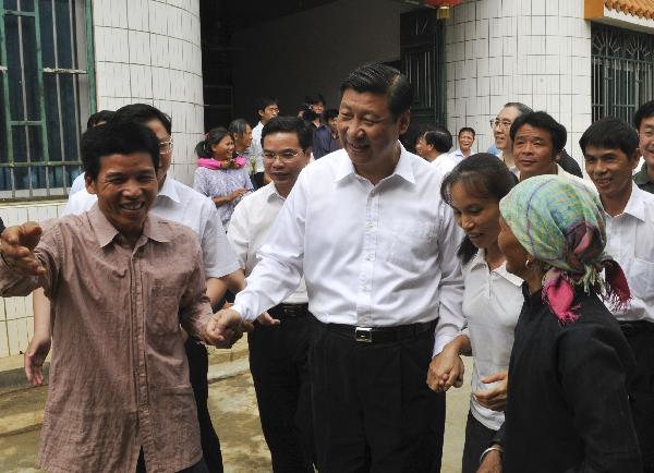 Chinese Vice President Xi Jinping (C Front) talks to local residents in Baise, south China's Guangxi Zhuang Autonomous Region, May 10, 2010. Xi went to Baise and Nanning from May 9 to 11 for an investigation. [Xinhua]