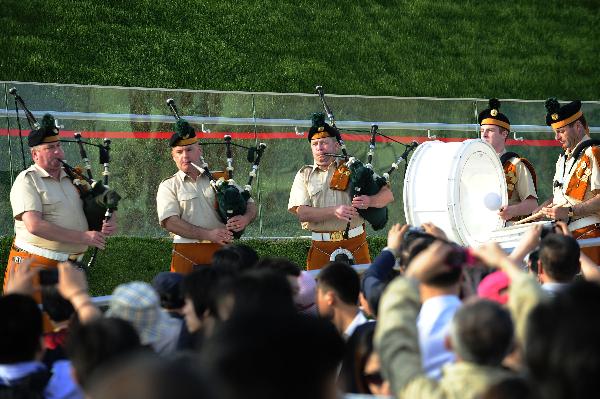 Members of a military band perform bagpipes in front of the Ireland Pavilion in the World Expo Park in Shanghai, east China, May 11, 2010. The military band will perform for visitors in Shanghai from May 9 to 12. 