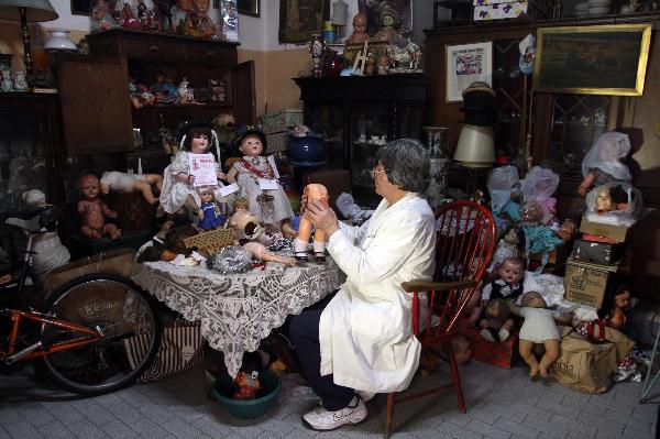 Doll repairman Julio Roldan works at his studio in Buenos Aires, capital of Argentina, May 11, 2010. Julio Rolda, also called doll's surgeon, has led this career for over 40 years. 