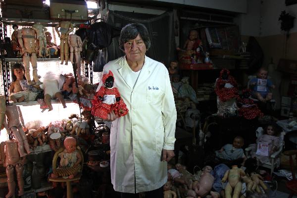 Doll repairman Julio Roldan works at his studio in Buenos Aires, capital of Argentina, May 11, 2010. Julio Rolda, also called doll's surgeon, has led this career for over 40 years. 