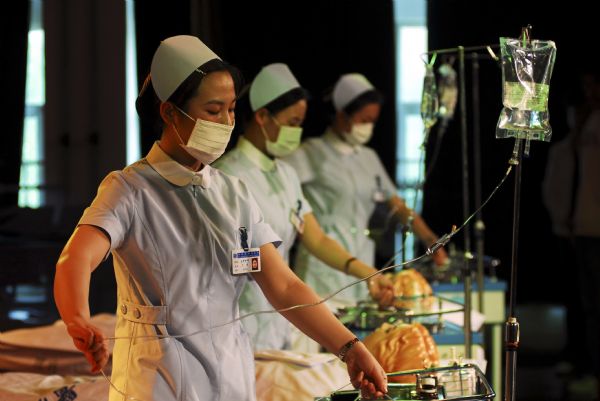 Three nurses show up their professional skills in an activity of marking the International Nurses Day, which falls on May 12 at the Nurse School of Yantai, Shandong Province, May 11, 2010. 