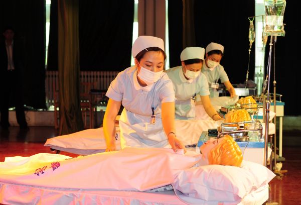 Three nurses show up their professional skills in an activity of marking the International Nurses Day, which falls on May 12 at the Nurse School of Yantai, Shandong Province, May 11, 2010. 