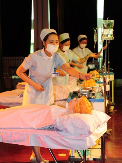 Three nurses show up their professional skills in an activity of marking the International Nurses Day, which falls on May 12 at the Nurse School of Yantai, Shandong Province, May 11, 2010.