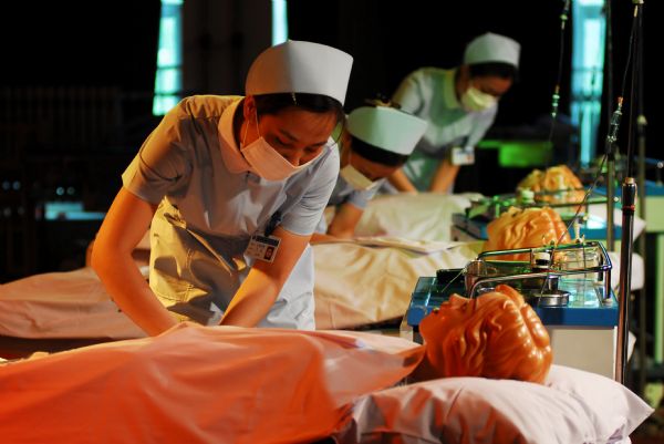 Nurses show up their professional skills in an activity of marking the International Nurses Day, which falls on May 12 at the Nurse School of Yantai, Shandong Province, May 11, 2010. 