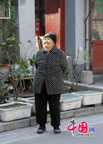 An elderly resident takes a walk around the hutong area surrounding Beijing's Drum and Bell Towers. The area is to be redeveloped this year under a controversial plan drawn up by the district government.