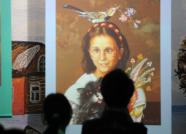 Two visitors appreciate a painting in Belarus Pavilion at the World Expo Park in Shanghai, east China, May 11, 2010.