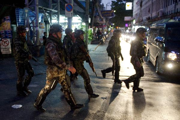 Thai soldiers patrol nearby the 'red-shirt' rally site in Thailand's capital Bangkok, on May 13, 2010. Amid the intense political situation due to the antigovernment rally in central Bangkok, an explosion was heard at a rally site on Thursday evening. Injuries were also reported. [Xinhua] 