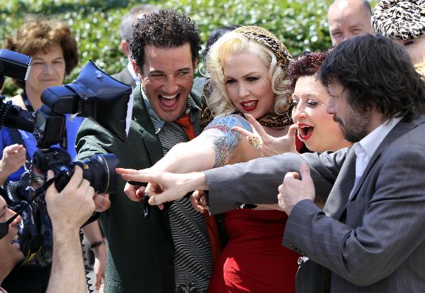 French director Mathieu Amalric (R) poses for a group photo with cast members of his film 'On Tour' during the debut in the 63rd International Film Festival of Cannes in Cannes of France, May 13, 2010.