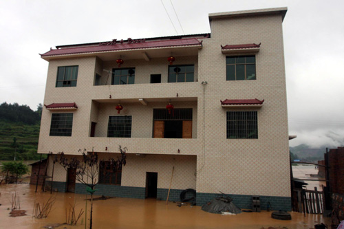 A house is soaked in flood water in a village in Loudi, central China's Hunan province on May 13, 2010. 