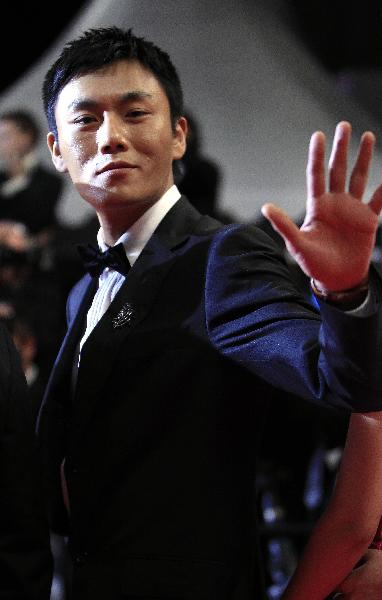 Chinese actor Qin Hao arrives on the red carpet for the screening of the film 'Rizhao Chongqing' (Chongqing Blues) presented in competiton at the 63rd Cannes Film Festival in Cannes, France, May 13, 2010. 