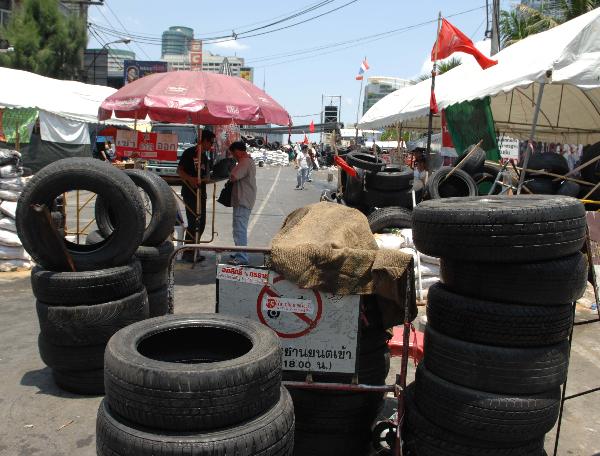 Thai 'Red Shirt' protesters set roadblocks in a street of Bangkok, capital of Thailand, on May 15, 2010. The intense political situation has continued in Bangkok on Saturday. [Xinhua/Thana Nuntavoranut]