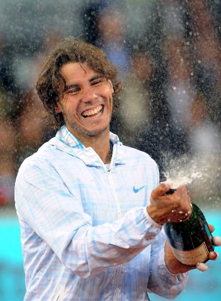 Rafael Nadal sprays sparkling wine during the podium ceremony Madrid Open tennis tournament final against Roger Federer in Madrid, on Sunday, May 16, 2010. (Xinhua Photo)