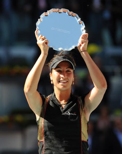 Aravane Rezai of France holds up the trophy during the awarding ceremony after the women's singles final at the Madrid Open in Madrid, Spain, May 16, 2010. Rezai defeated Venus Williams of the United States 2-0 and claimed the title. (Xinhua/Chen Haitong)