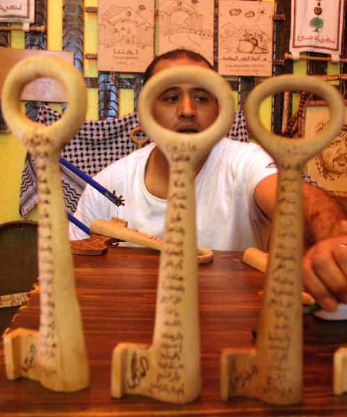  Palestinian sculpture artist Nasser Flefel, 39, shows wooden keys decorated with the names of villages which were occupied during the war with Israel in 1948 in his wood-carving shop in Gaza City, May 16, 2010.