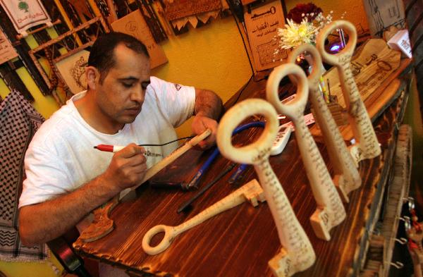  Palestinian sculpture artist Nasser Flefel, 39, carves wooden keys and decorates them with the names of villages which were occupied during the war with Israel in 1948 in his wood-carving shop in Gaza city, May 16, 2010. 