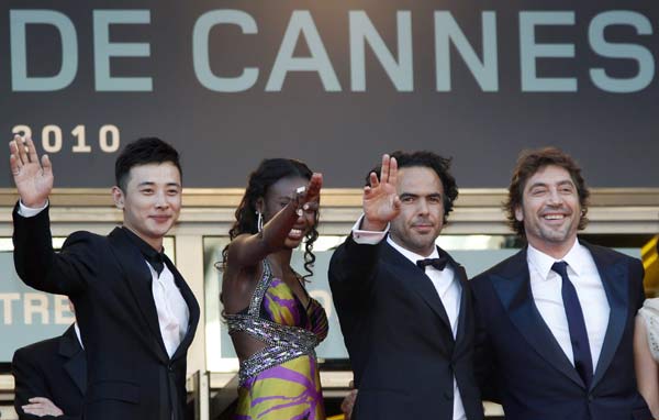 Director Alejandro Gonzalez Inarritu poses with cast members (L-R) Luo Jin, Diaryatou Daff and Javier Bardem as they arrive on the red carpet for the screening of the film 'Biutiful' in competition at the 63rd Cannes Film Festival May 17, 2010. Nineteen films compete for the prestigious Palme d'Or which will be awarded on May 23. 