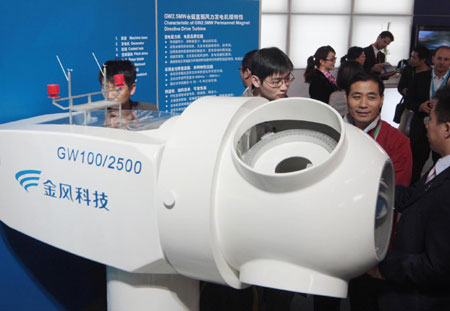 Visitors looking at a Goldwind turbine at a wind power exhibition in Beijing. The wind power equipment maker expects overseas sales will account for up to 30 percent of its business over the next three to five years. 