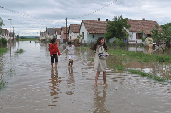 Locals walk on a flooded street in Boldva village, some 200 kms northeast from Budapest, capital of Hungary, May 17, 2010.