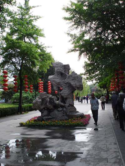A visitor walks past a rock landscape inspired by China's most famous literary work, 'Dream of the Red Mansion,' inside the Beijing Grand View Garden. The television series 'Dream of the Red Mansion' was filmed there. [Photo: CRIENGLISH.com] 