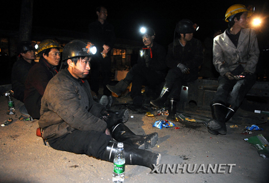 Coal miners wait for news of trapped workers in the morning of May 19, 2010. Twelve miners were confirmed trapped underground after a coal mine explosion on May 18 in Yuxian County, north China's Shanxi Province, local authorities said. 