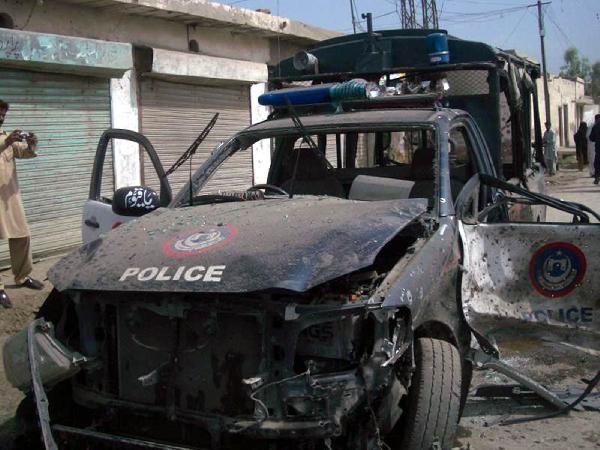 Photo taken on May 18, 2010 shows a damaged police vehicle in the planted bomb blast in northwest Pakistan's Dera Ismail Khan. At least 12 people were killed and 15 injured in the bomb attack targeting a police vehicle on Tuesday.