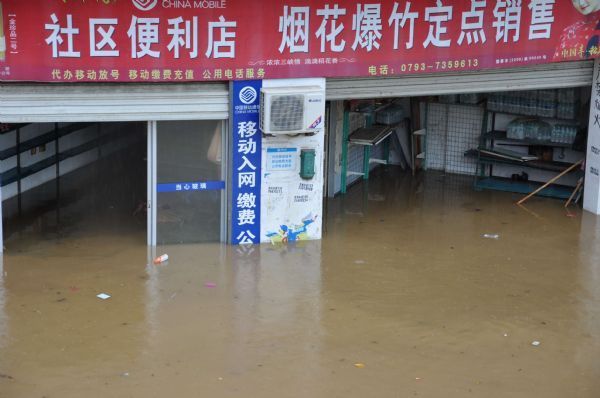 Two shops are flooded in Wuyuan County, Jiangxi Province, May 18, 2010. A heavy rainfall hit the county on May 17 and 18. More than 9,300 people have been evacuated. 