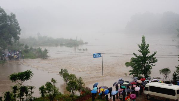 A bridge is flooded at Zhucun Village in Wuyuan County, Jiangxi Province, May 18, 2010. A heavy rainfall hit the county on May 17 and 18. More than 9,300 people have been evacuated. 