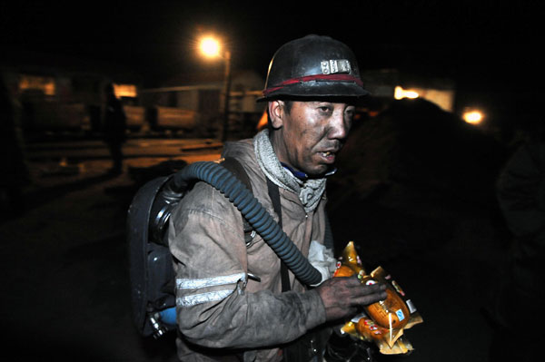 A rescue worker walks out of a coal mine of Chentong Coal Industry Co., Ltd. in Yuxian County, Shanxi Province, May 19, 2010. A gas explosion happened to the mine on May 18, killing at least 10 people. One miner is still missing. 