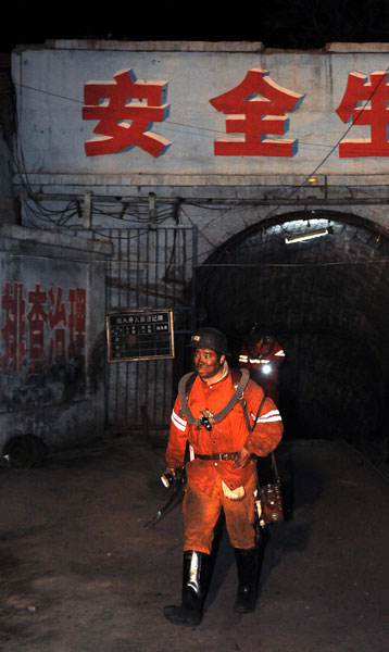 A rescue worker walks out of a coal mine of Chentong Coal Industry Co., Ltd. in Yuxian County, Shanxi Province, May 19, 2010. A gas explosion happened to the mine on May 18, killing at least 10 people. One miner is still missing.