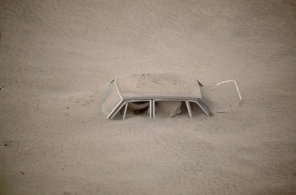 A car is shown submerged in ash in this May 20, 1980 photo from Mount St. Helens eruption in Washington State. 