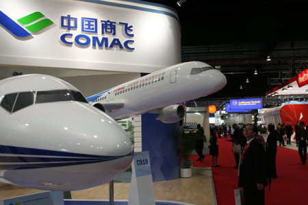 A visitor looks at the C919 aircraft mockup at the Singapore Airshow.
