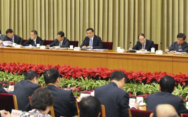 Chinese Vice Premier Li Keqiang (4th L back) addresses a meeting concerning reform on health care system in Beijing, capital of China, May 21, 2010. [Li Xueren/Xinhua]